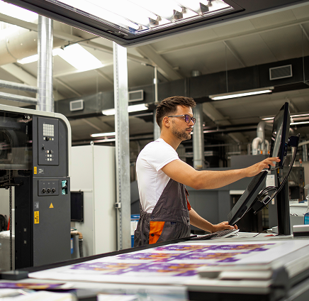 Worker operating a printing machine